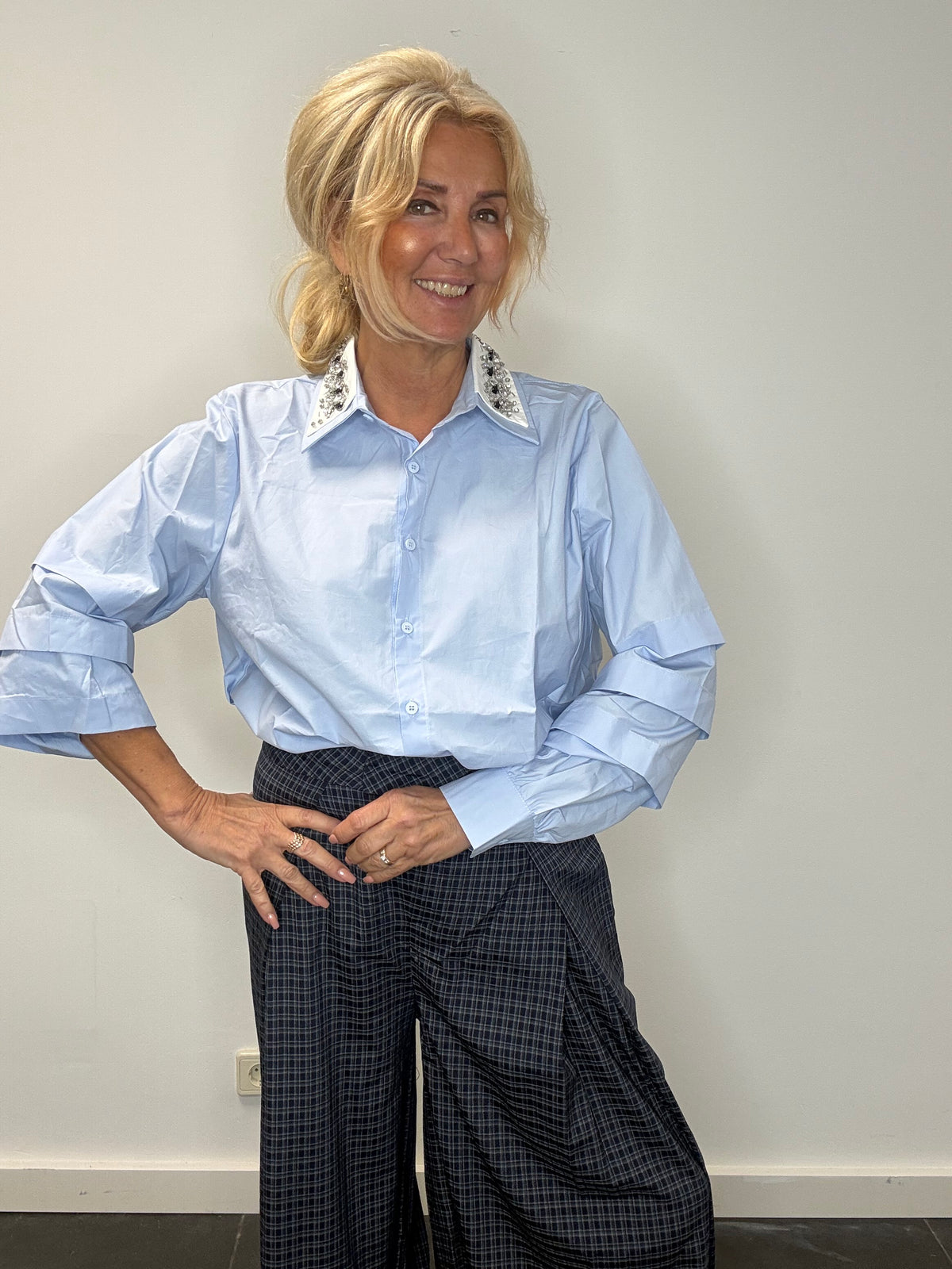 Light blue blouse with a white collar and rhinestones